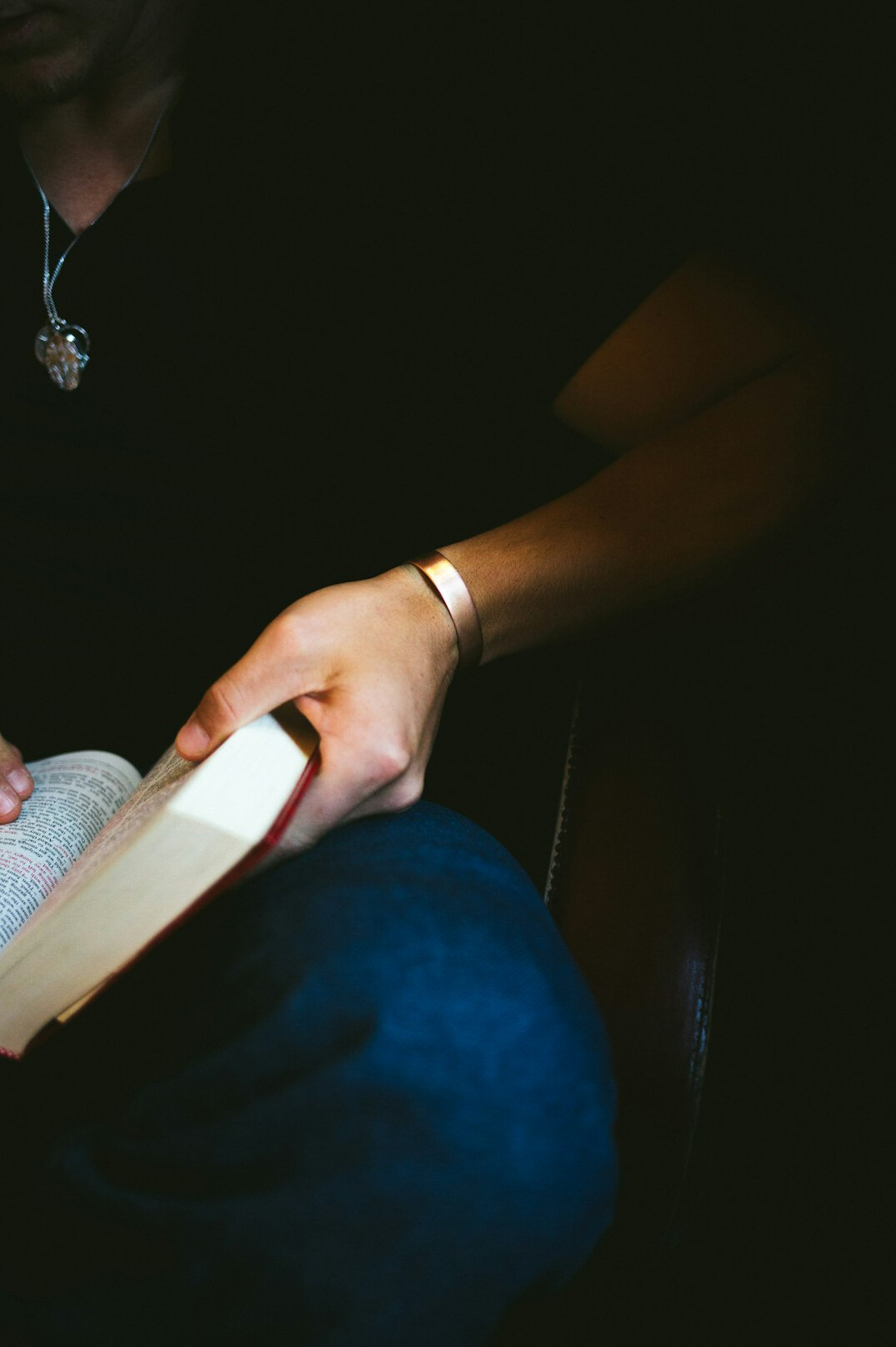 person reading mystery book at night